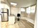 Kitchen area with stainless steel fridge, counter seating, and plenty of natural light from the windows at 347 W Trade St, Burlington, NC 27217