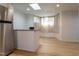 Kitchen features stainless steel refrigerator, breakfast bar, and natural light at 347 W Trade St, Burlington, NC 27217