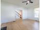 Spacious living room featuring wood-look floors, white walls, and staircase at 347 W Trade St, Burlington, NC 27217