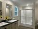 Bright bathroom with double sinks, modern fixtures, a glass-enclosed shower, and neutral tones for a clean design at 349 Tristen Ln, Henderson, NC 27537