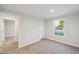 Bright bedroom featuring neutral carpet, fresh paint, and a window allowing natural light at 349 Tristen Ln, Henderson, NC 27537