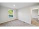 Bedroom with neutral walls and carpet and a window providing natural light at 349 Tristen Ln, Henderson, NC 27537