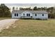 Charming one-story home with gray siding, front porch, and inviting curb appeal at 349 Tristen Ln, Henderson, NC 27537
