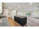 Kitchen island with gray countertop overlooks a living area with natural lighting at 349 Tristen Ln, Henderson, NC 27537