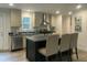 Modern kitchen featuring stainless steel appliances, a center island with seating, and ample cabinet space at 349 Tristen Ln, Henderson, NC 27537