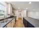 A modern kitchen features stainless steel appliances, light cabinets, and a black island at 349 Tristen Ln, Henderson, NC 27537