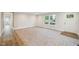 Expansive living room with ample space, neutral carpet, and large windows providing natural light and views at 349 Tristen Ln, Henderson, NC 27537
