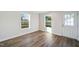 Bright living room with two windows and beautiful wood-look flooring and white trim and door at 349 Tristen Ln, Henderson, NC 27537