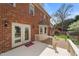 Inviting back deck and landscaped yard viewed from the exterior of a brick two story home at 3529 Elk St, Burlington, NC 27215