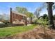 Backyard includes a wooden deck, green lawn, and mature trees at 3529 Elk St, Burlington, NC 27215