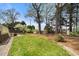 Backyard featuring a green lawn, mature trees, a garden and a storage shed at 3529 Elk St, Burlington, NC 27215