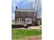 Expansive backyard of brick two story home featuring a lush lawn, patio, and inviting deck at 3529 Elk St, Burlington, NC 27215