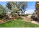 Lush backyard featuring a brick patio, wooden deck and mature landscaping at 3529 Elk St, Burlington, NC 27215