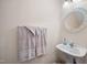 This bathroom features a pedestal sink, round mirror and neutral colored towels at 3529 Elk St, Burlington, NC 27215