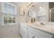 Bathroom featuring double sinks, white cabinets, and a well-lit mirror at 3529 Elk St, Burlington, NC 27215