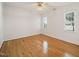 This bedroom features hardwood floors, two windows and a ceiling fan at 3529 Elk St, Burlington, NC 27215