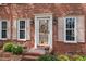 Close up of the home's entry with wreath, sidelights, and lush landscaping at 3529 Elk St, Burlington, NC 27215