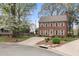 Charming two-story brick home with a manicured front lawn and mature trees, creating inviting curb appeal at 3529 Elk St, Burlington, NC 27215