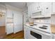 Efficient kitchen with white appliances and access to a separate dining area at 3529 Elk St, Burlington, NC 27215