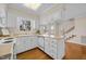 Bright kitchen with white cabinetry, neutral countertops, and an abundance of natural light at 3529 Elk St, Burlington, NC 27215