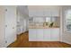 Cozy kitchen features white cabinets, classic appliances, and lots of storage at 3529 Elk St, Burlington, NC 27215