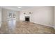 Open concept living room with tile floors and access to a wooden porch through glass doors at 3529 Elk St, Burlington, NC 27215