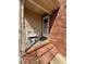 Covered brick front porch with a bench and decorative pots, offering a cozy welcome at 3529 Elk St, Burlington, NC 27215