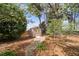 Backyard with a small shed, stone pathway, and lush landscaping at 3529 Elk St, Burlington, NC 27215