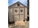 Exterior view of a backyard storage shed with decorative accents and a small ramp entrance at 3529 Elk St, Burlington, NC 27215