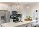 Bright, modern kitchen with white cabinetry, stainless steel appliances, a stylish backsplash, and a quartz-topped island at 359 Church St # 60, Wendell, NC 27591