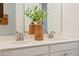 Bathroom vanity featuring dual sinks, a large mirror, and wooden decorative accents at 361 Church St # 59, Wendell, NC 27591