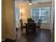 Bright and inviting dining area with a round wood table and large window at 3710 Pardue Woods Pl # 103, Raleigh, NC 27606