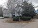 Multi-story condo building with well-maintained landscaping and mature trees at 3710 Pardue Woods Pl # 103, Raleigh, NC 27606