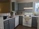 A spacious kitchen featuring sleek gray cabinets and modern white appliances at 3710 Pardue Woods Pl # 103, Raleigh, NC 27606