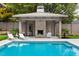 Backyard pool with a pool house and a patio featuring lounge chairs and a swing at 4300 Camelot Dr, Raleigh, NC 27609