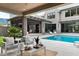Spacious backyard featuring a modern pool, cozy outdoor seating, and lush landscaping at 4300 Camelot Dr, Raleigh, NC 27609