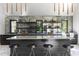 Stylish bar area with a white countertop and wooden shelves stocked with liquor bottles at 4300 Camelot Dr, Raleigh, NC 27609