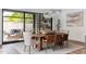 Bright dining room with wood table, modern chandelier, and large sliding glass doors at 4300 Camelot Dr, Raleigh, NC 27609