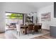Bright dining room with wood table, modern chandelier, and large sliding glass doors at 4300 Camelot Dr, Raleigh, NC 27609