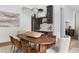 Bright dining room with wood table, modern chandelier, and view of the kitchen at 4300 Camelot Dr, Raleigh, NC 27609