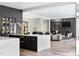 Open concept kitchen with dark cabinets and white island flowing into the living room at 4300 Camelot Dr, Raleigh, NC 27609