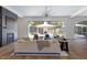 Open concept living room with pool view through sliding glass doors and modern fireplace at 4300 Camelot Dr, Raleigh, NC 27609