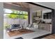 Covered outdoor patio features a kitchen, seating, and a view of the backyard at 4300 Camelot Dr, Raleigh, NC 27609
