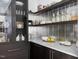 View of walk-in pantry with white countertops, dark cabinets, and decorative shelving at 4300 Camelot Dr, Raleigh, NC 27609