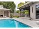 Inviting pool area featuring a covered patio with stylish seating and well-maintained landscaping at 4300 Camelot Dr, Raleigh, NC 27609
