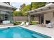 Stunning pool and patio area with fireplace, outdoor kitchen, and pristine landscaping at 4300 Camelot Dr, Raleigh, NC 27609