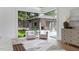 Bright sun room overlooking the backyard pool and patio with comfortable white chairs at 4300 Camelot Dr, Raleigh, NC 27609