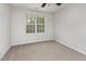 Bright bedroom with neutral carpet and paint and one large window at 4308 Brynwood Ave, Durham, NC 27713