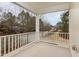 The covered porch area features a white railing overlooking the neighborhood street and mature trees at 4308 Brynwood Ave, Durham, NC 27713