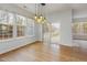 Sunlit dining area featuring wood floors, bright windows, and modern lighting fixture at 4308 Brynwood Ave, Durham, NC 27713